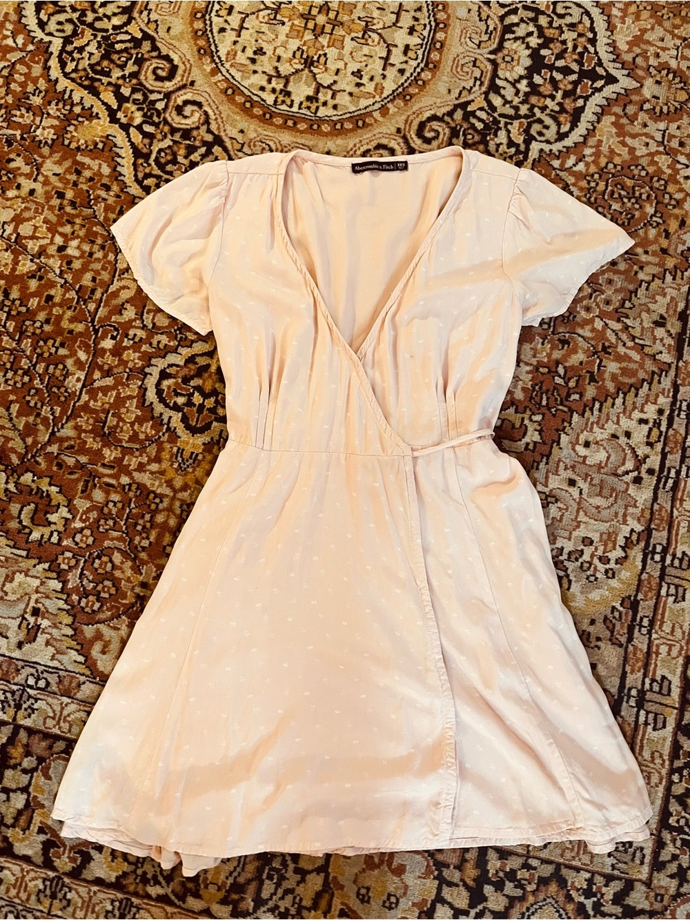 Abercrombie and Fitch Light Pink Wrap Dress with Subtle White Pattern Design